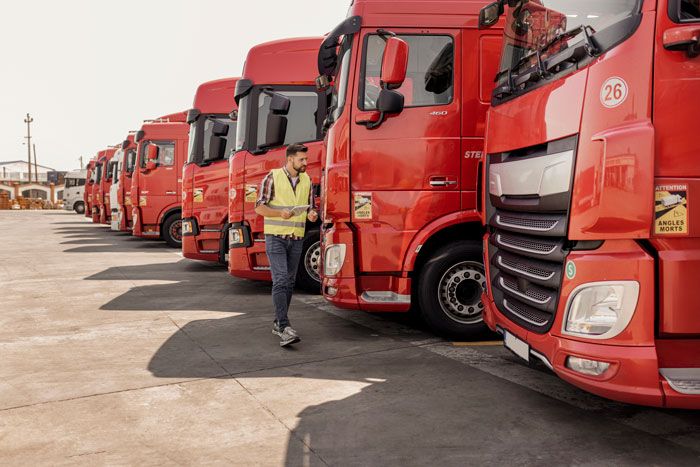 A business owner reviews his fleet of trucks.