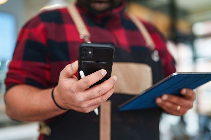 A business owner reviews the app associated with his fuel card.