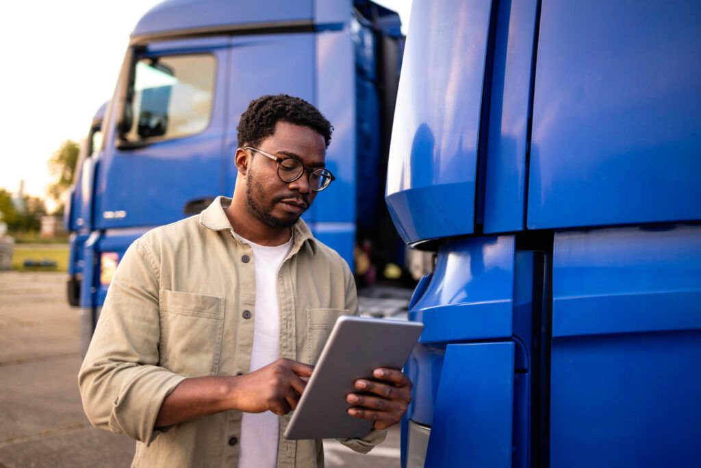 A fleet owner reviews on a tablet the analytics of the usage from his team’s fuel cards.